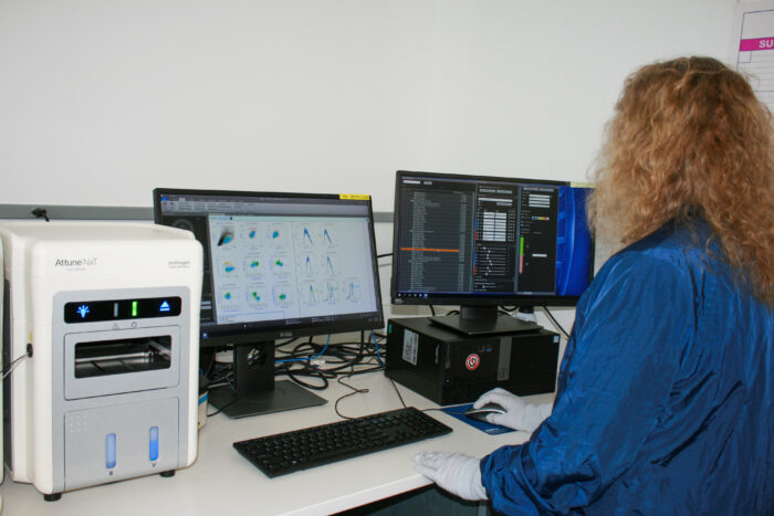 A lab technician analyzes cell data